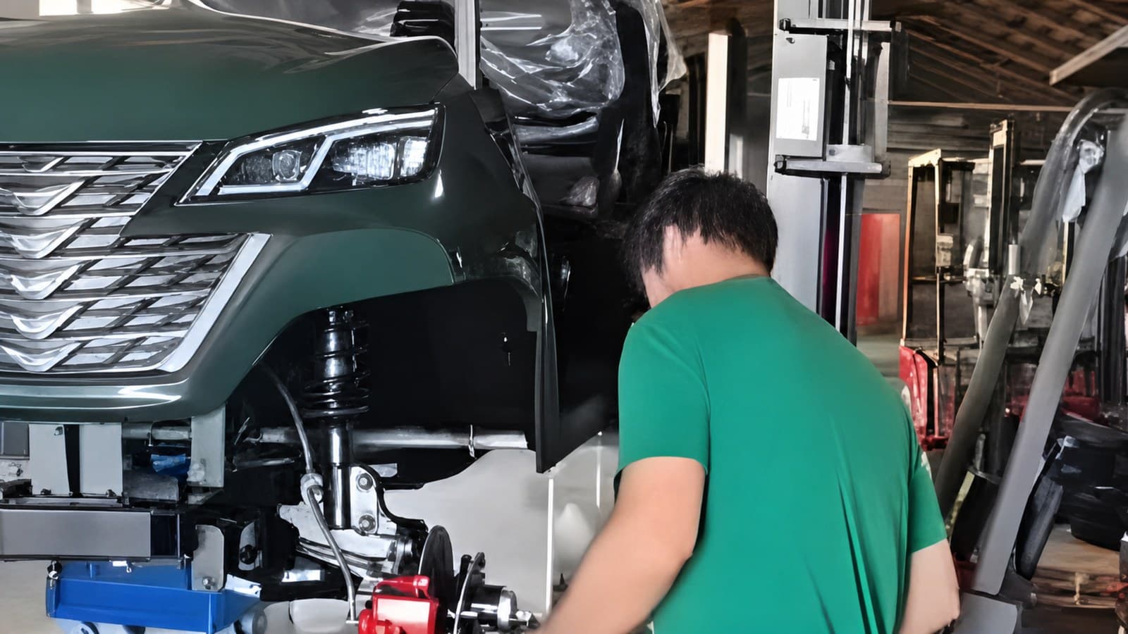 Technician servicing a lifted golf cart at the U.S. parts and service facility in Wheatland, Missouri